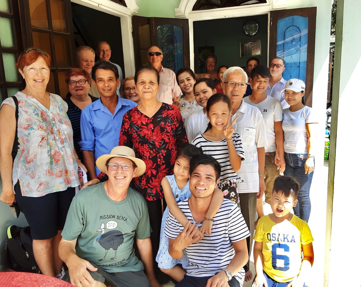 Jerry Coleby-Williams and Thuan squat at the front of a big family group