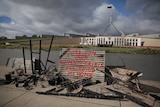 Several charred items sitting in front of Canberra's Parliament House.