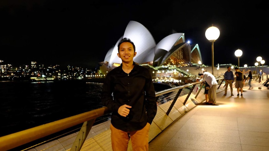 Aulia Rifqiandono stands in front of the Sydney Opera House.