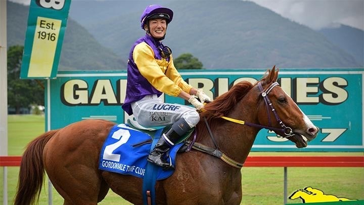 Jockey Manabu Kai on his horse on the racehorse in his silks.