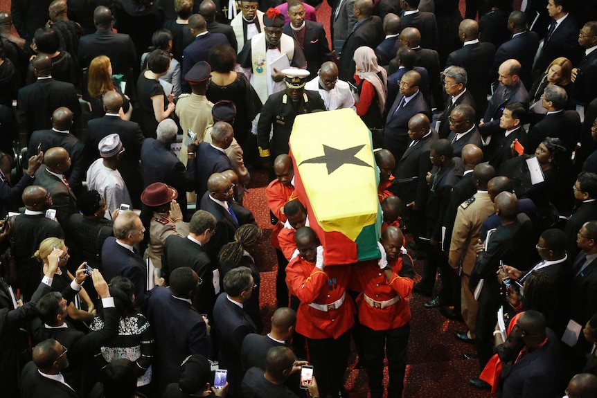 Soldiers carry the coffin of former UN secretary-general Kofi Annan through a crowd of mourners.