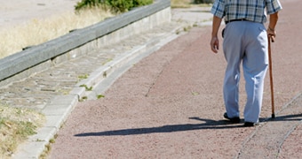 An old man walking with a cane