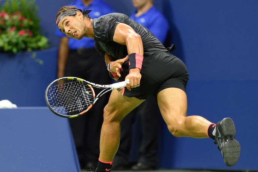 Rafael Nadal runs into a shot against Fabio Fognini