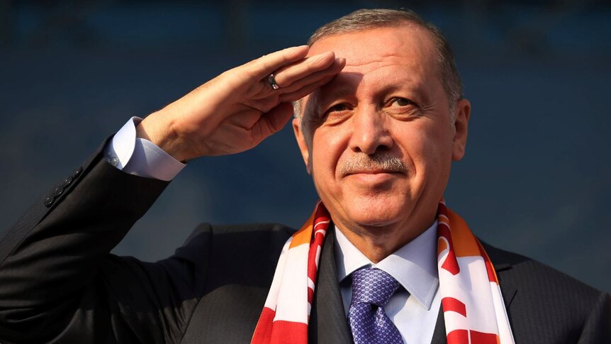 Recep Tayyip Erdogan salutes towards the camera.