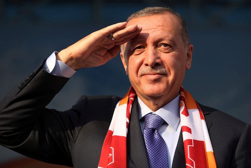 Recep Tayyip Erdogan salutes towards the camera.