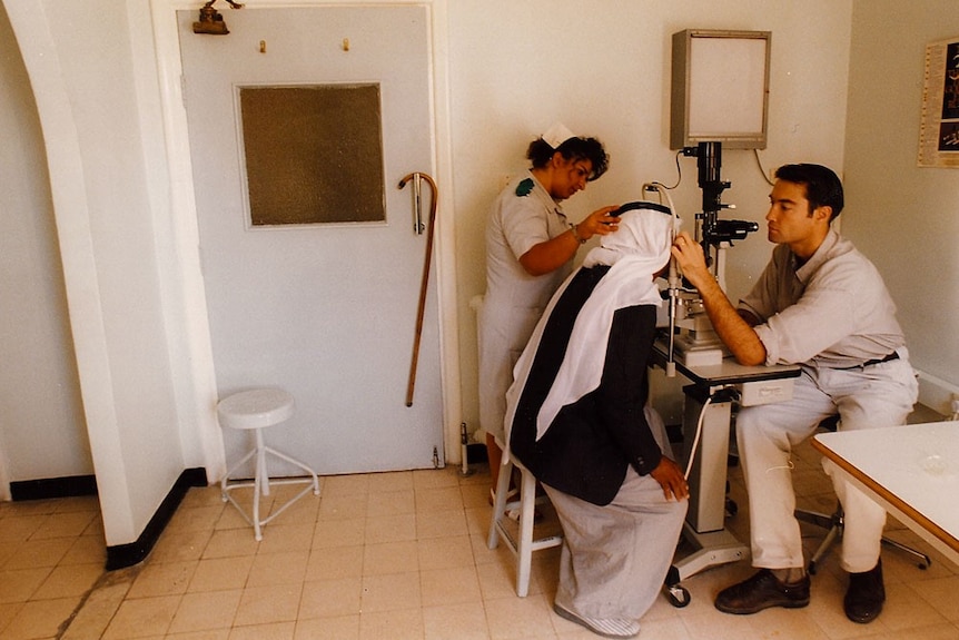James Muecke performs an eye test on a woman in Jerusalem.