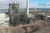 Dust rises from demolition work at a power station.