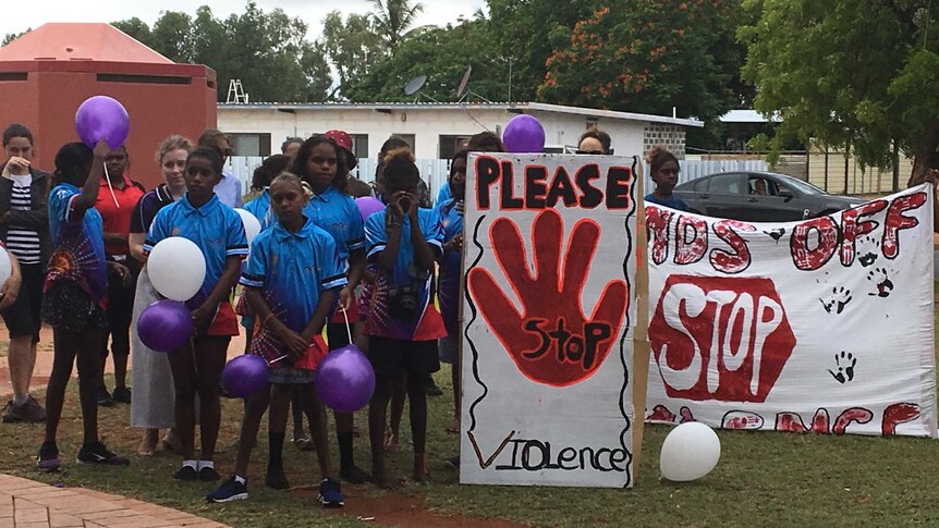 Tennant Creek children hold signs protesting violence.