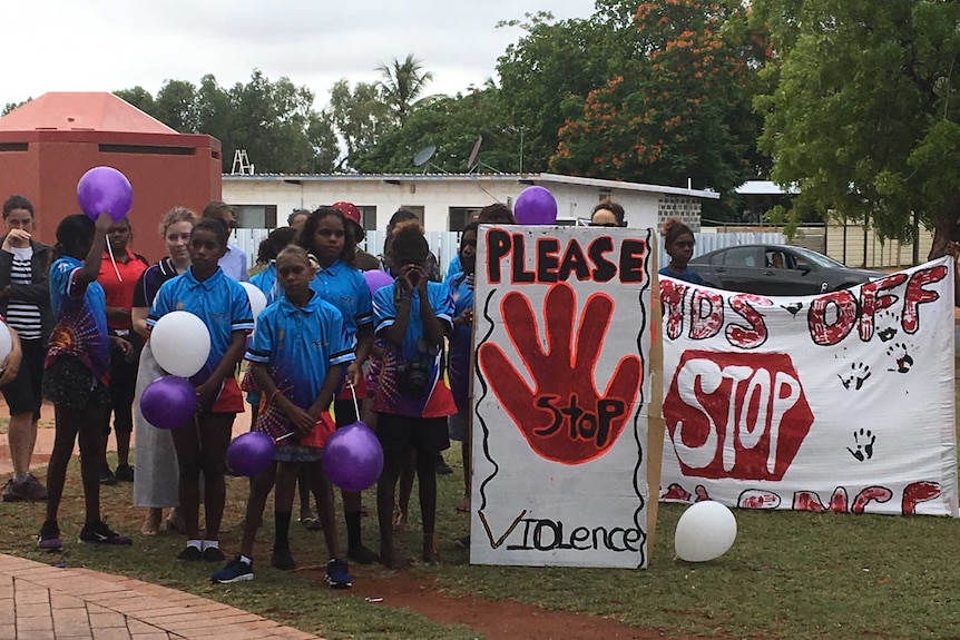 Tennant Creek children hold signs protesting violence.