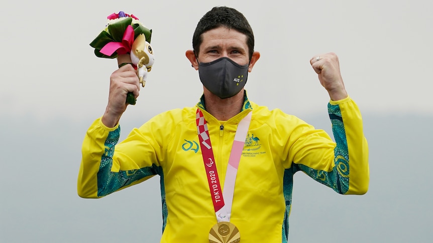 Paralympian on the medal podium after winning gold in the men's cycling