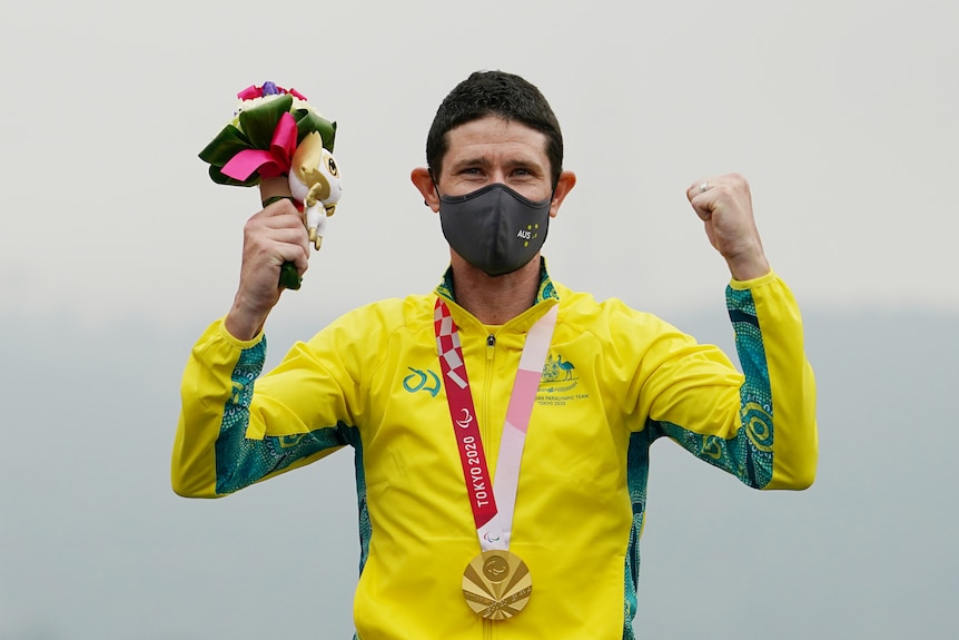 Paralympian on the medal podium after winning gold in the men's cycling