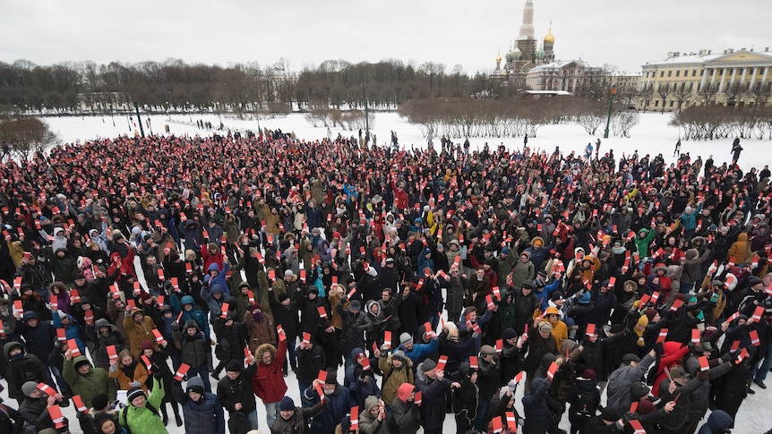 Hundreds of people turn up to vote, while standing on ground that is covered by snow.