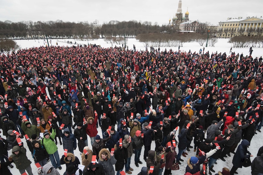 Hundreds of people turn up to vote, while standing on ground that is covered by snow.