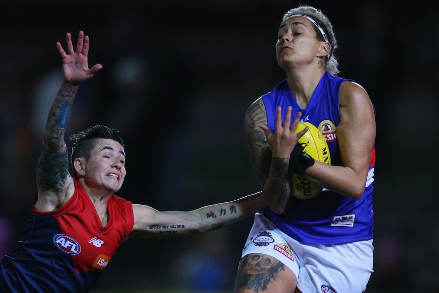 Western Bulldogs' Moana Hope marks over Melbourne's Ceceila McIntosh in AFL Women's All-Stars game.