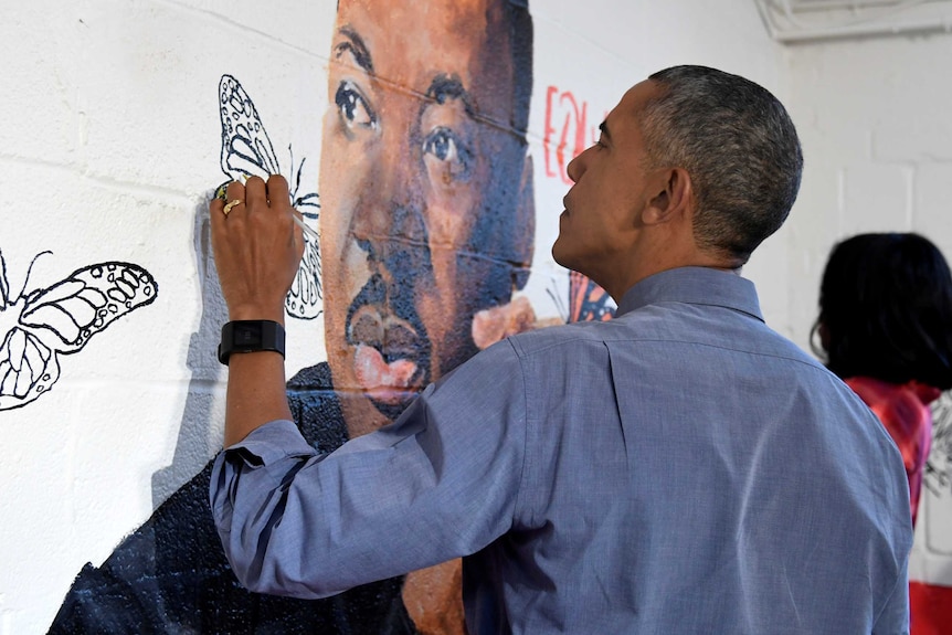 Barack Obama helps finish a mural of Martin Luther King Jr