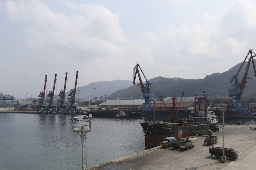 A shipping port lined with cranes.