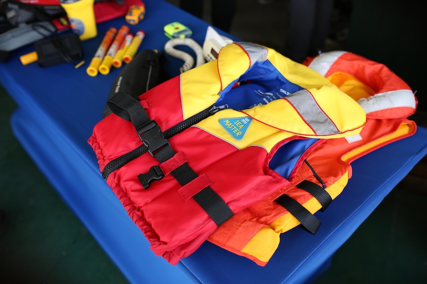 A standard-issue life jacket for boats laid out on a table