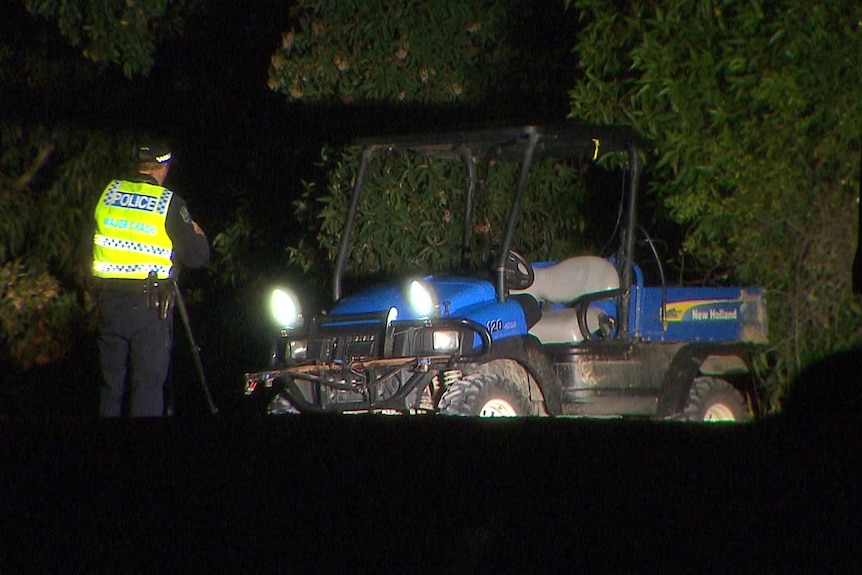 A police officer inspects a blue buggy vehicle