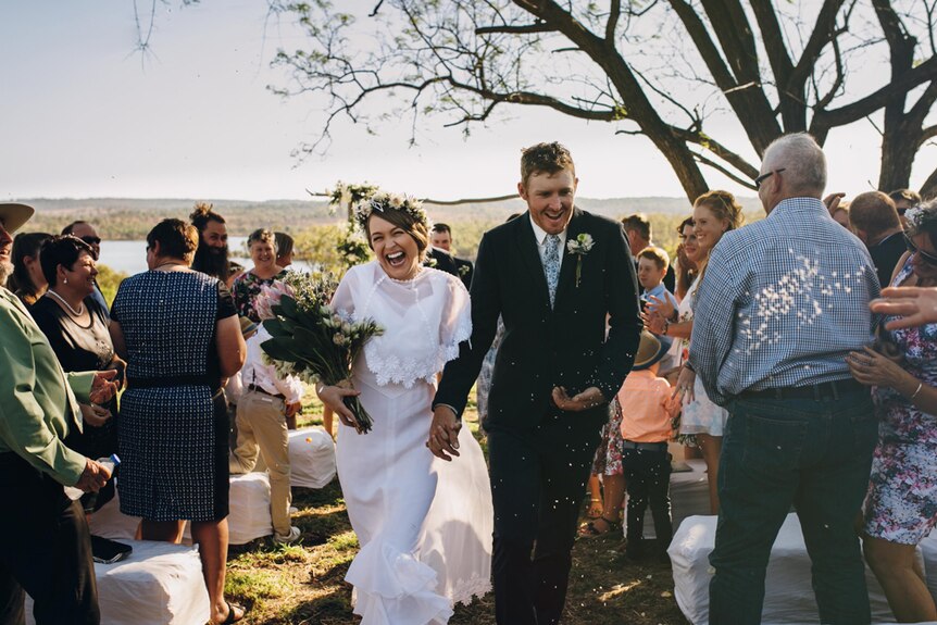 Couple walking down the aisle after getting married.