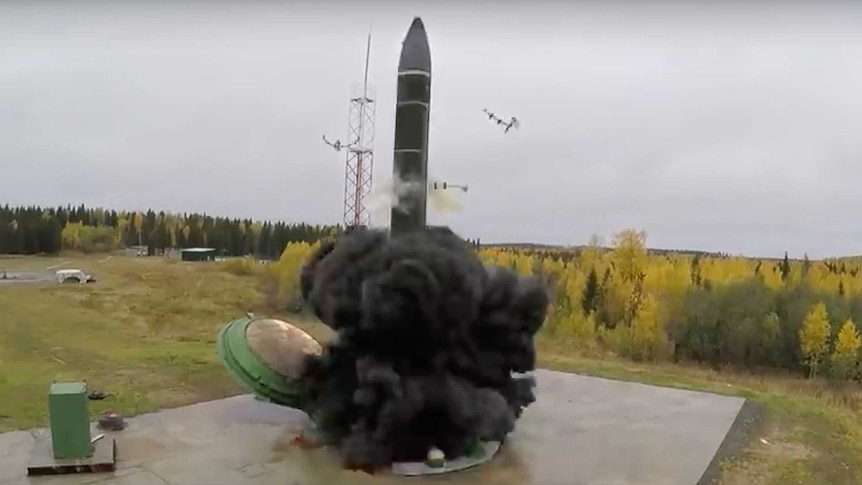 A missile launching in a cloud of dark grey smoke