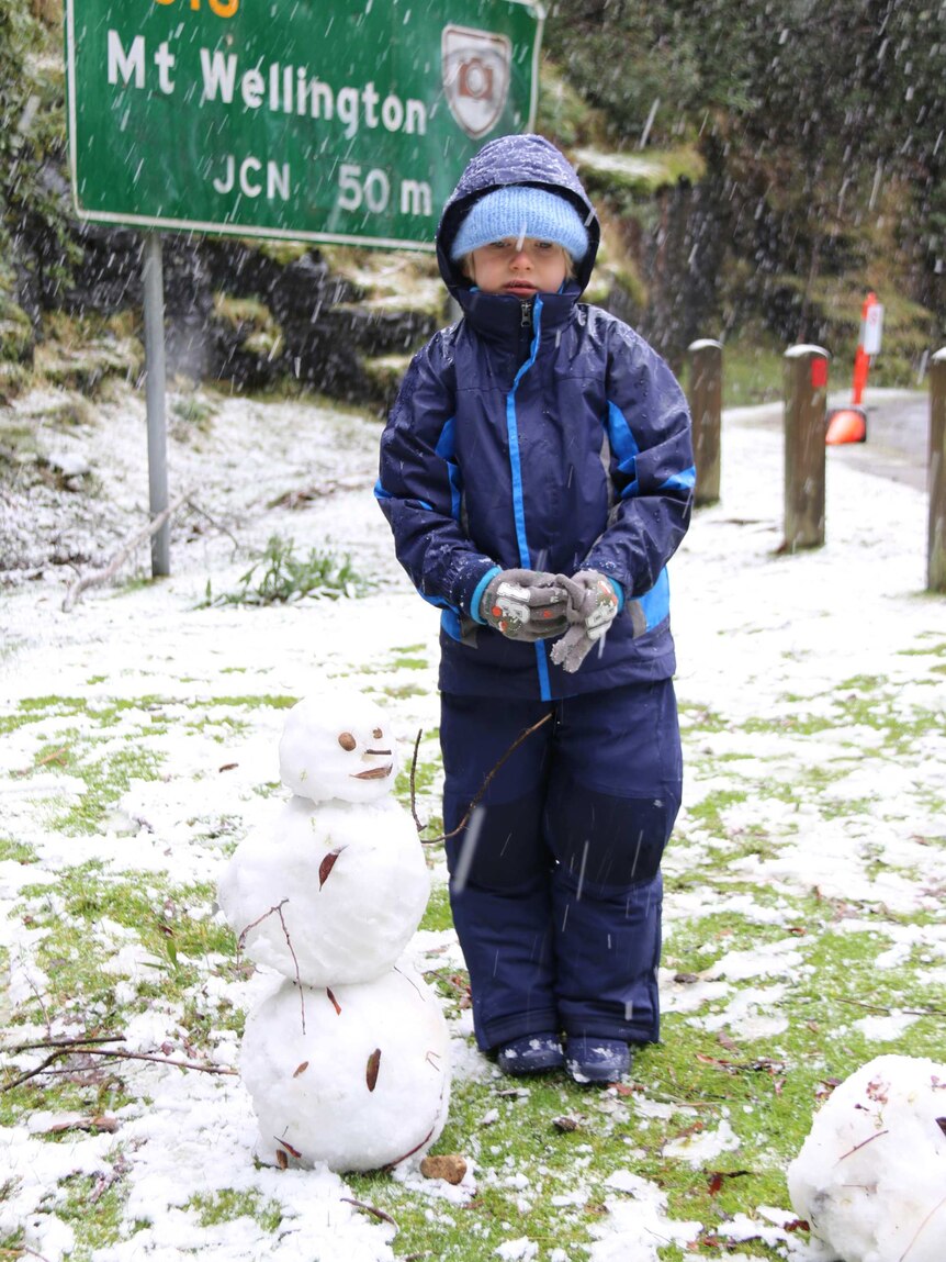 A child in the snow with a snowman on Mount Wellington / kunanyi June 2016