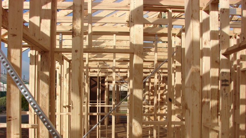 A timber house frame under construction.