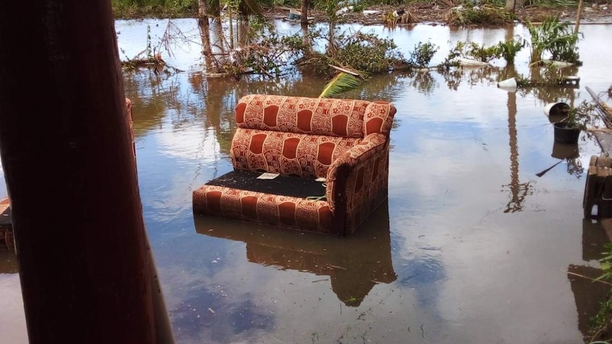 A chair in the middle of flood water