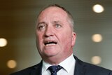 Barnaby Joyce wearing a suit and tie mid-sentence gesturing with his hands