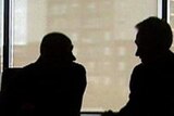 Silhouette of financial planner with client.