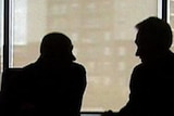 Financial planner with client in silhouette
