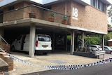 Forensic experts are examining the Newcastle unit where a woman was stabbed to death.