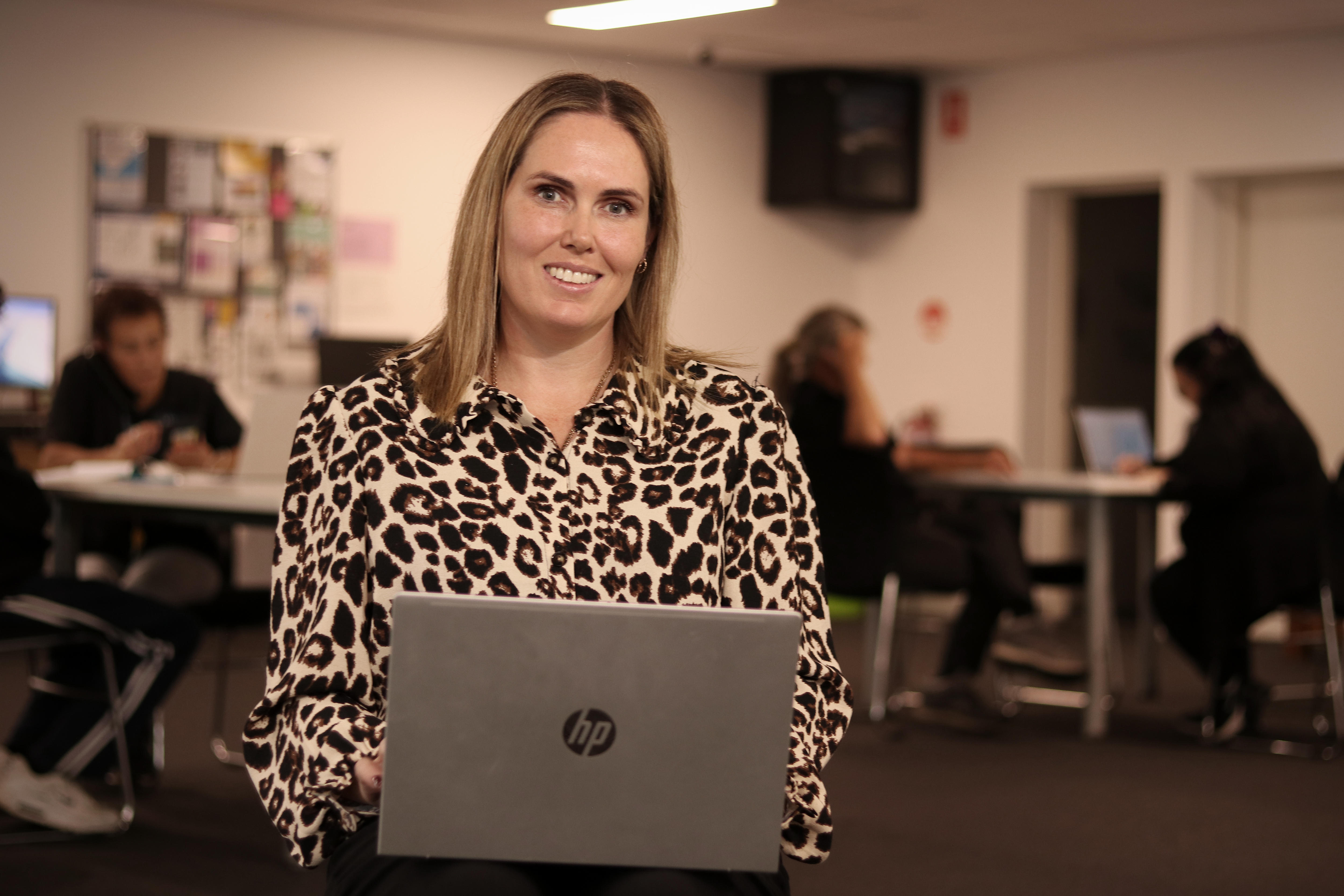 woman with laptop smiling