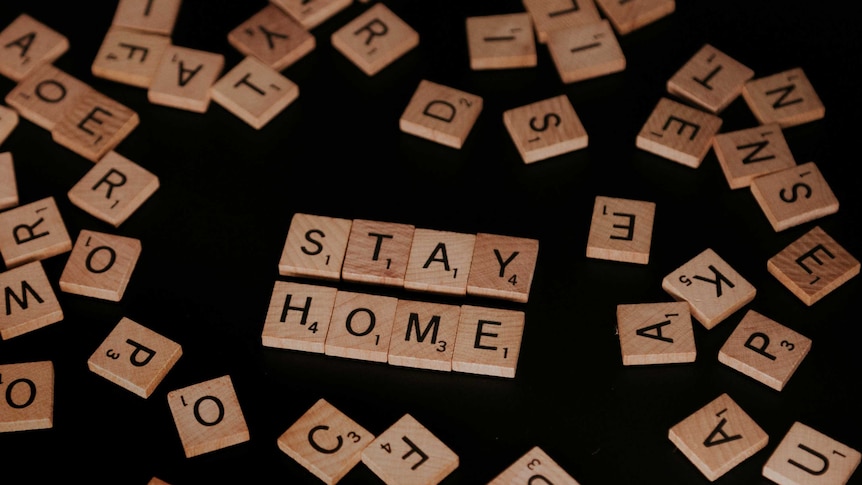 Scrabble tiles spell out Stay Home