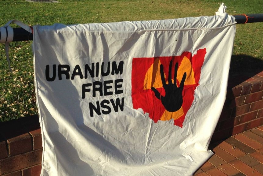 A sign that says "uranium free NSW" hanging up at a protest