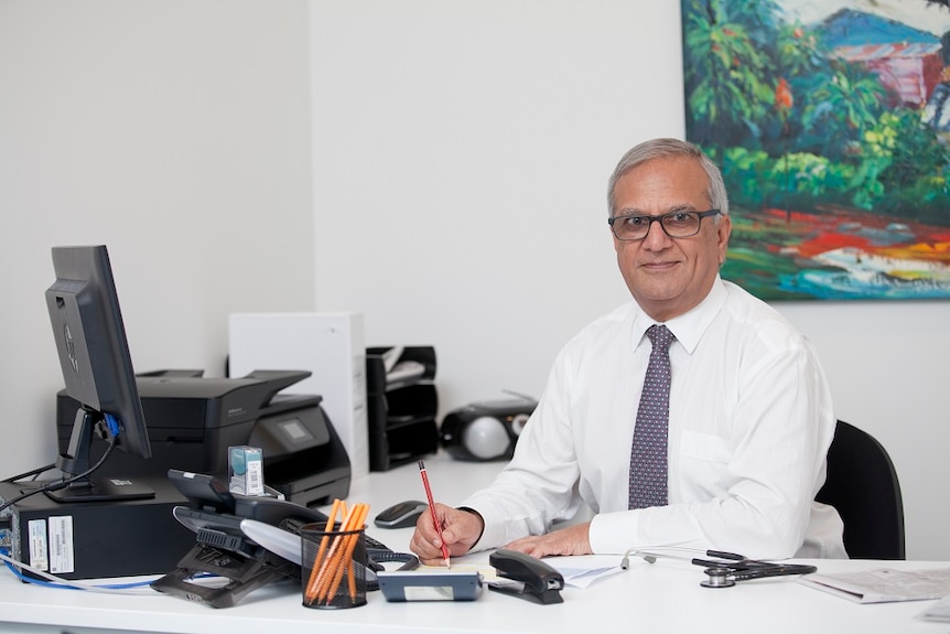 A man sits at a desk