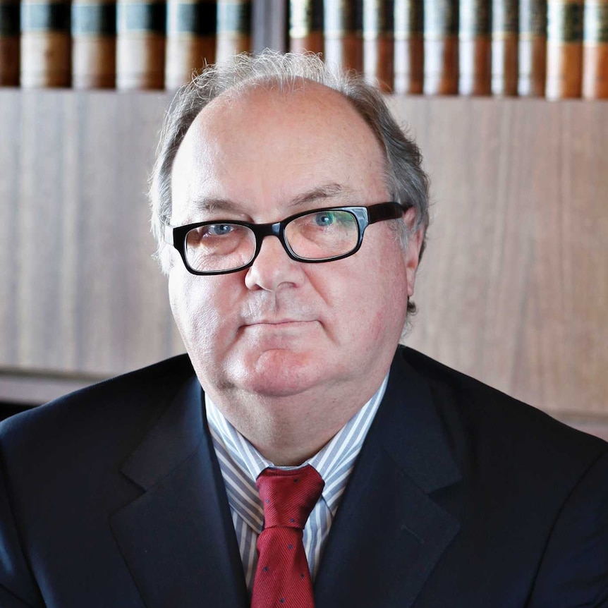 Official portrait of Justice Patrick Keane in front of a bookcase.