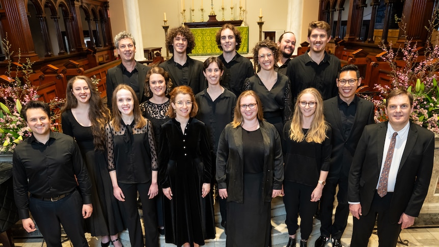 The members of the Choir of St James standing in front of the alter at the church on King Street