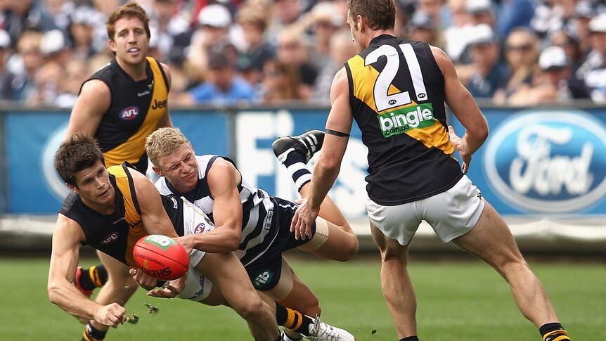 Gotcha ... Geelong's Taylor Hunt reels in Tigers star Trent Cotchin at Kardinia Park.