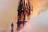 Flames and smoke engulf a gothic cathedral spire