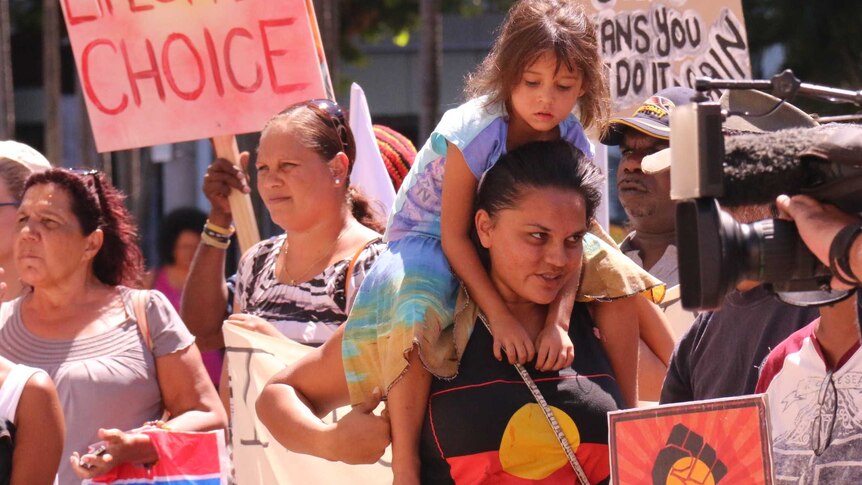 People in Darwin gather outside Parliament to protest a proposal to force the closure of up to 150 WA communities