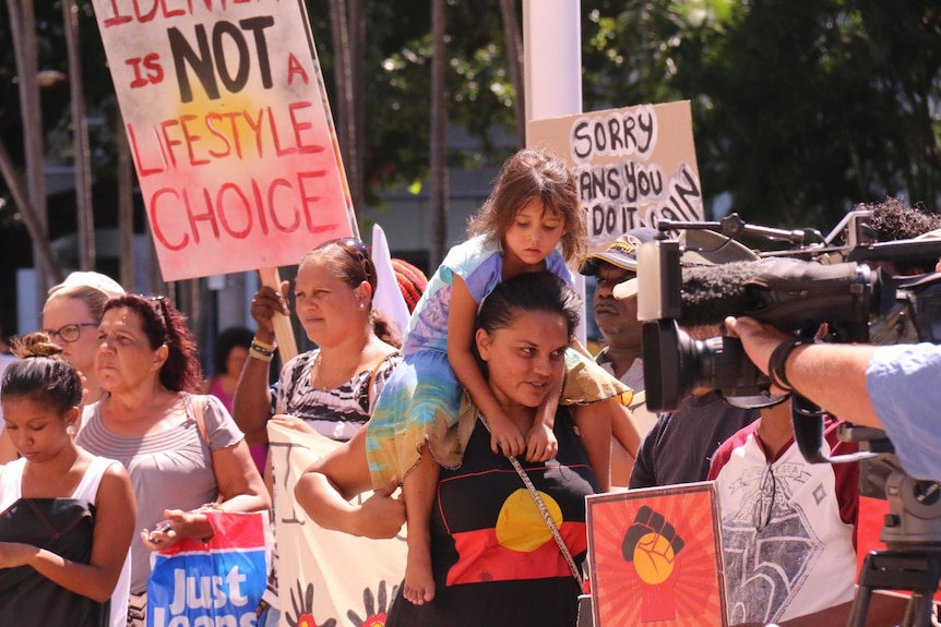 People in Darwin gather outside Parliament to protest a proposal to force the closure of up to 150 WA communities