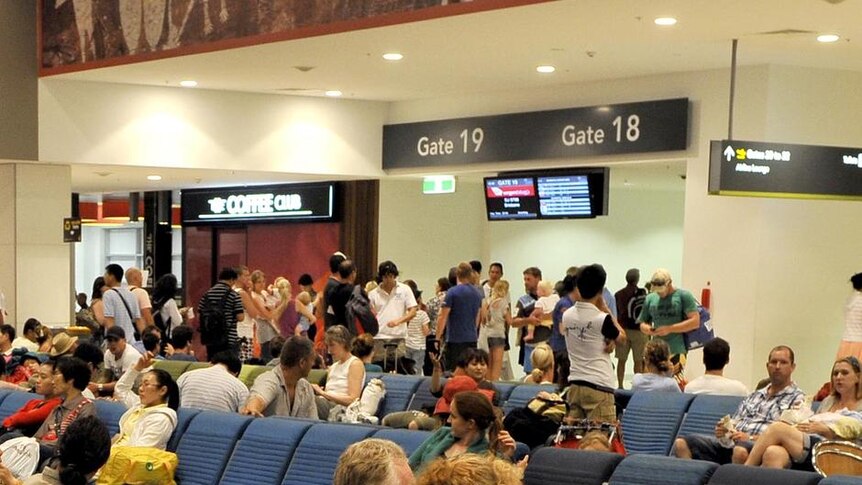 Travellers wait for flights to Brisbane at Cairns Airport ahead of Cyclone Yasi on February 2, 2011.