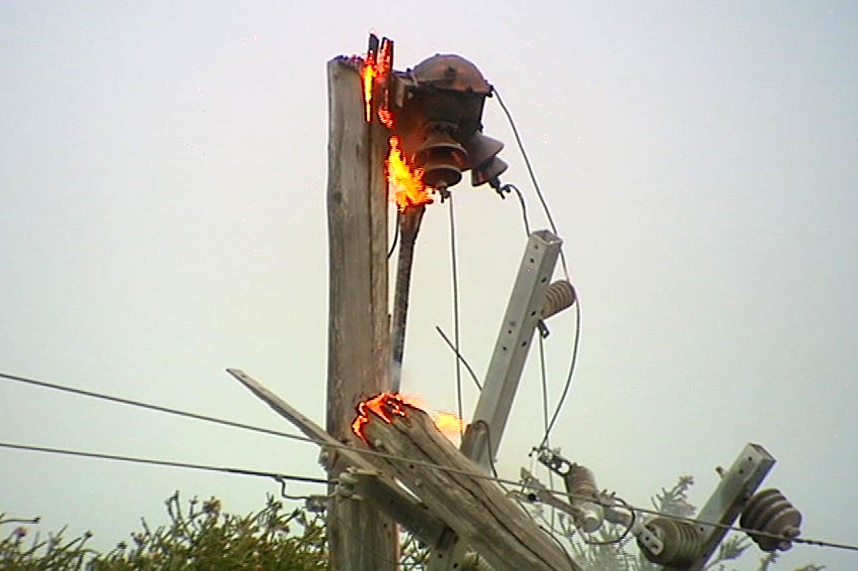 A power pole on fire.