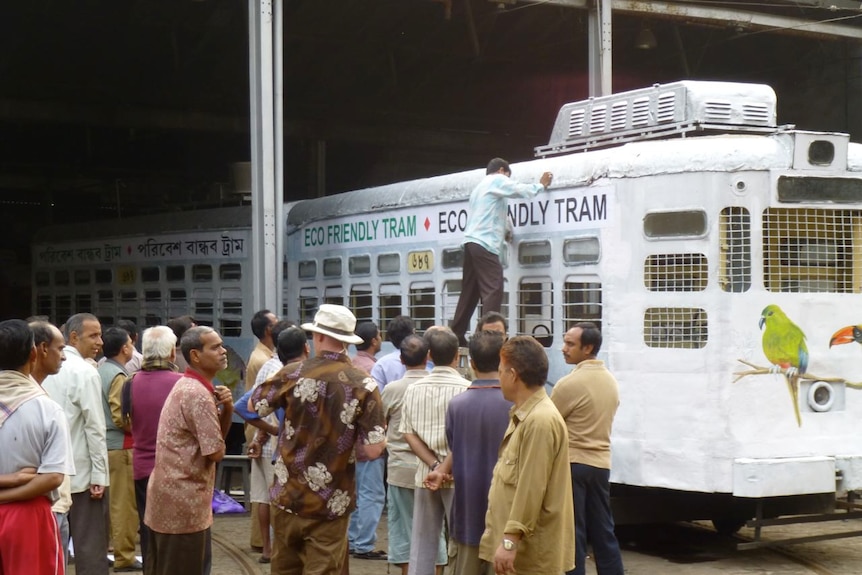 A picture of a tram with eco friendly signs being fitted