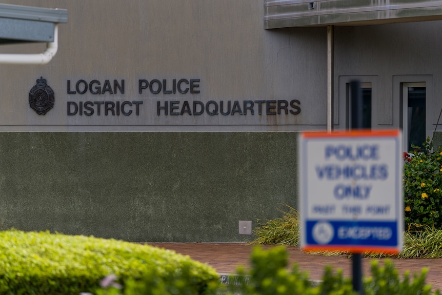 A building has the words "Logan Police District Headquarters" printed on its side.