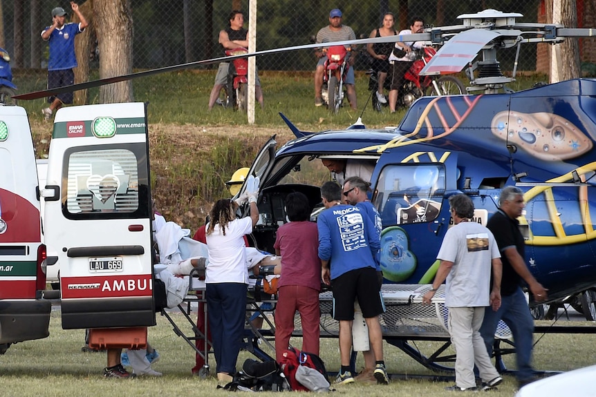 Injured spectator is loaded into a helicopter during Dakar Rally prologue