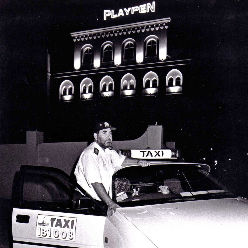 Taxi driver stands beside his car in 1998 outside a nightclub called the Playpen