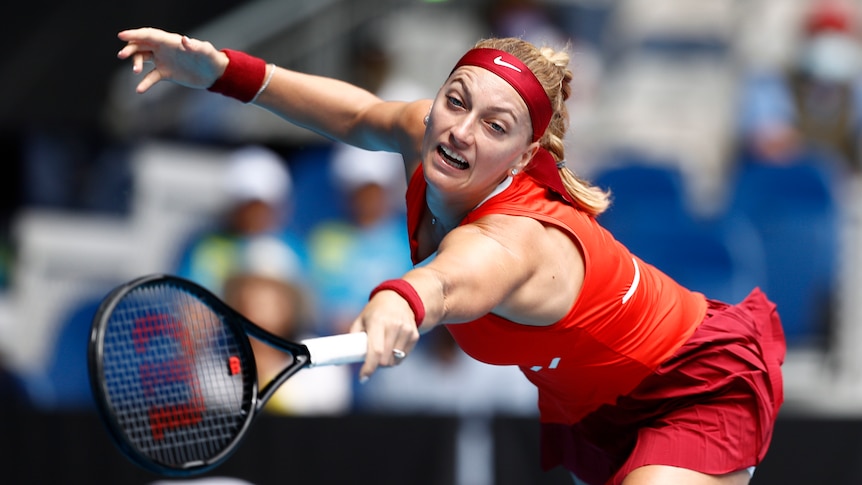 A Czech female tennis player stretches for a return in the Australian Open.