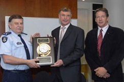 Commander James Hart presents the National SAR Award to Inspector Ross Paine and Mr Roger Corbin