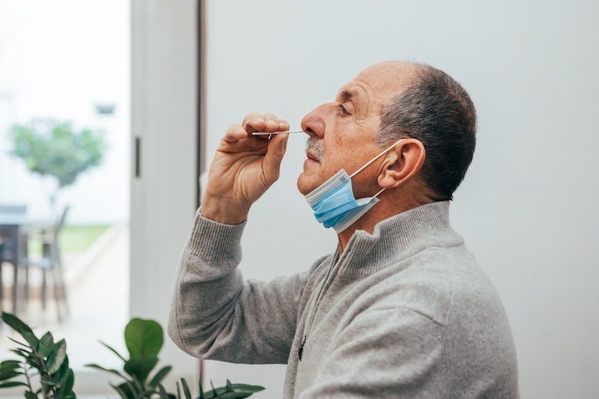 Man collects his own nasal swab.